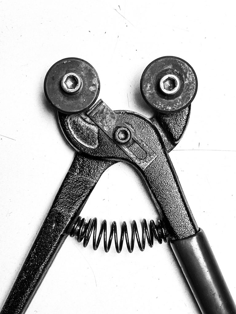 Black and white closeup of a glass cutting tool.